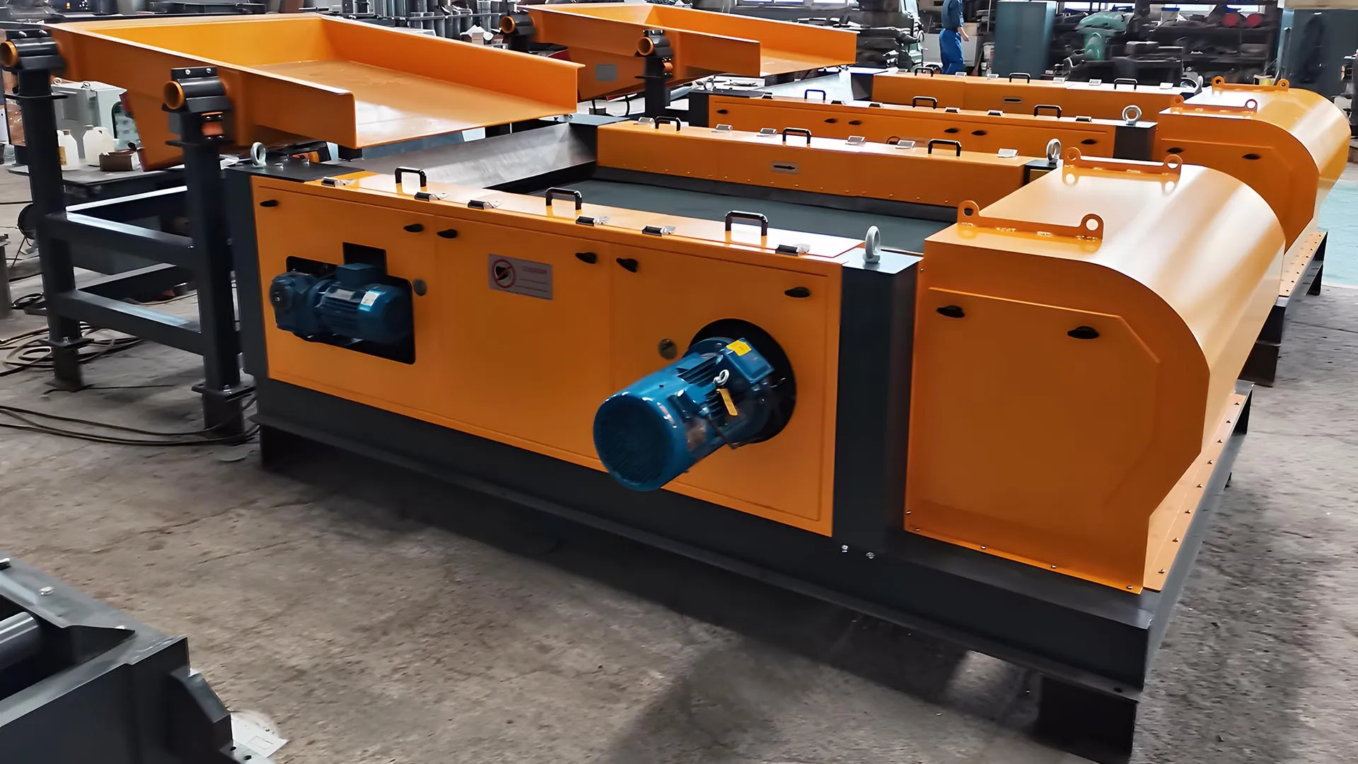 Advanced eddy current separator with orange and blue components, designed for efficient metal sorting in recycling operations.