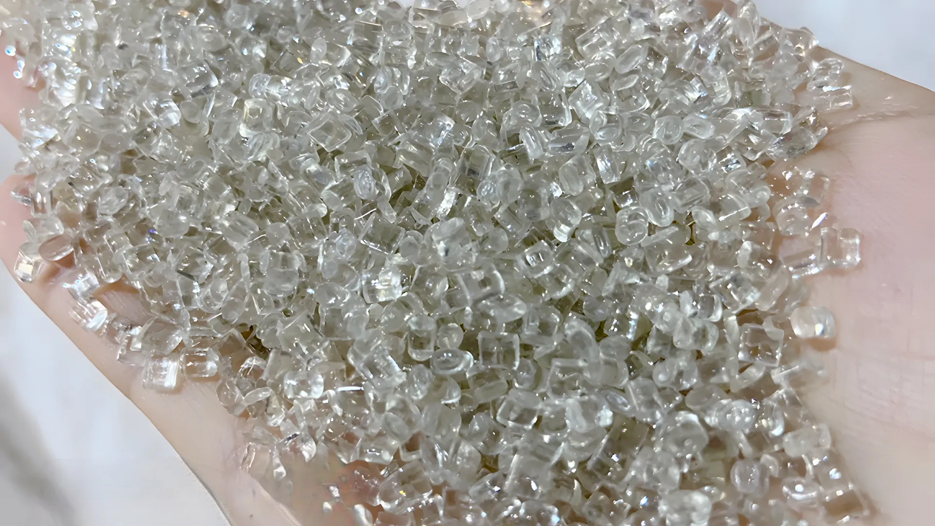 Transparent resin granules in hand