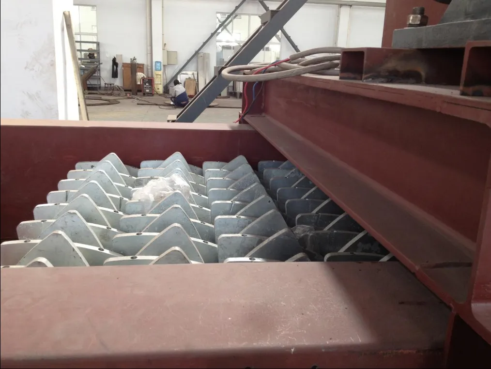 Industrial metal parts in red bin at manufacturing facility