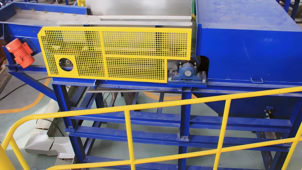 Industrial conveyor machine with blue and yellow accents