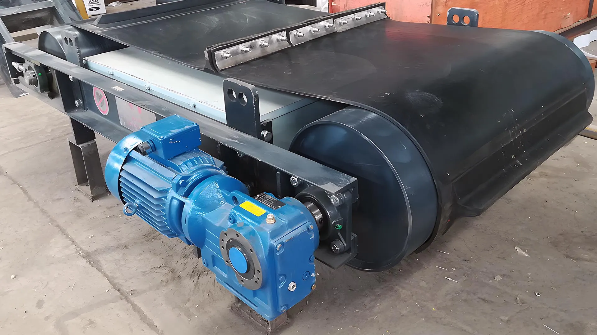 Modern suspension magnetic separator featuring a robust blue motor and a large black magnetic drum, designed for efficient metal separation in industrial settings