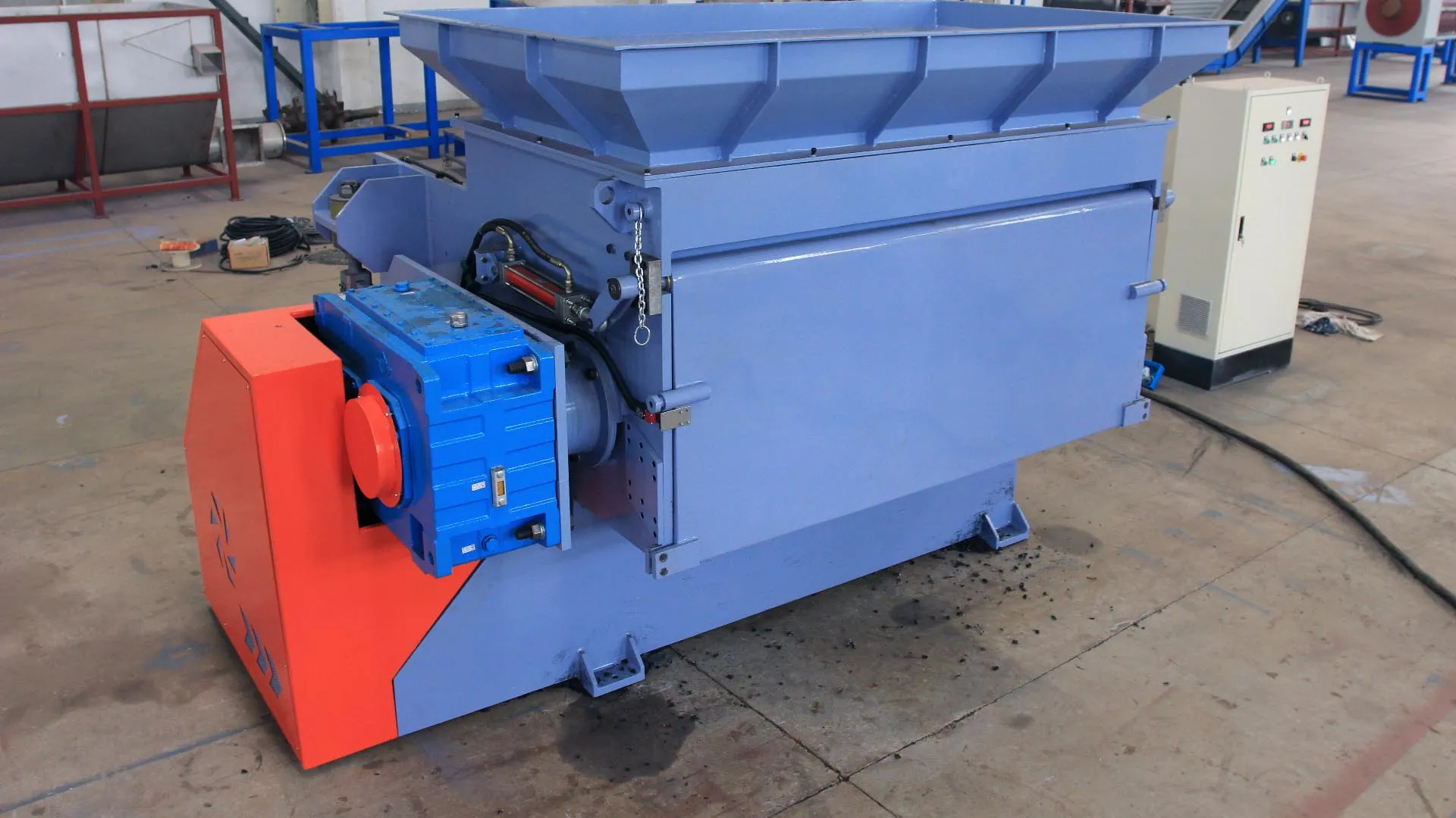 a standalone rigid plastic granulator machine. This machine appears to be a smaller, compact model suitable for processing moderate volumes of plastic materials. The large hopper at the top is designed for easy feeding of plastic waste, and the motor visible on the side powers the cutting mechanism inside.