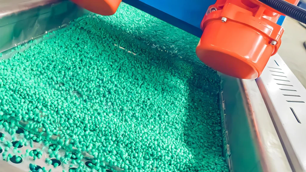 Green plastic pellets in industrial machine