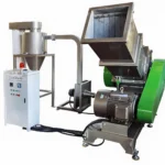 Industrial plastic granulator machine with an attached control panel and large feed hopper, used for recycling plastic materials into granules.